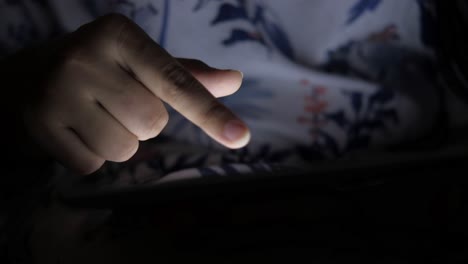 person using a tablet at night