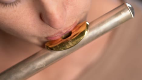 closeup macro lips blowing into and playing flute top view