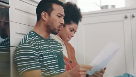 Stress,-taxes-and-documents-with-couple-in-kitchen