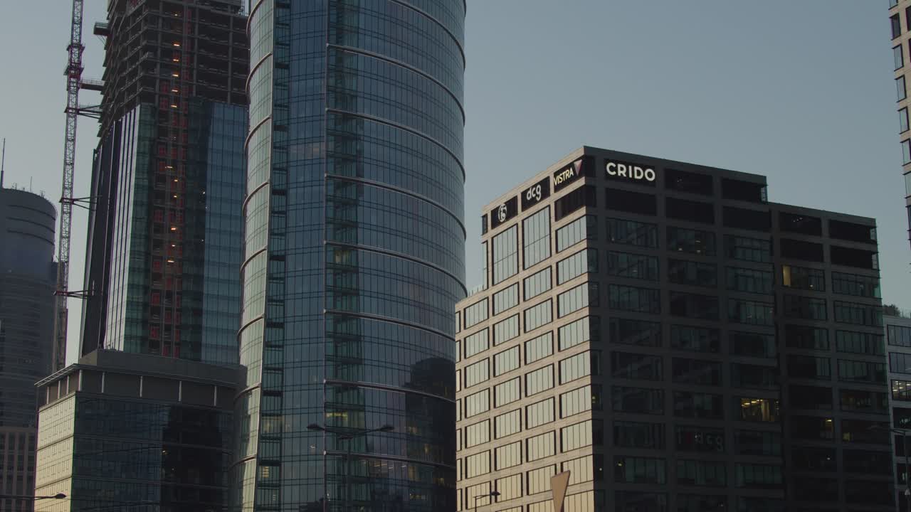 A slow, horizontal camera movement showcasing Warsaw's skyscrapers at twilight.