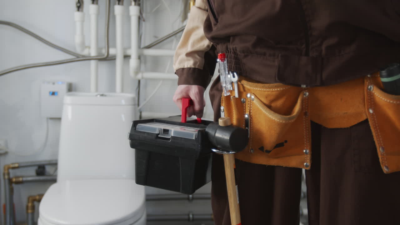 Unrecognizable Plumber with Tool Belt and Toolbox