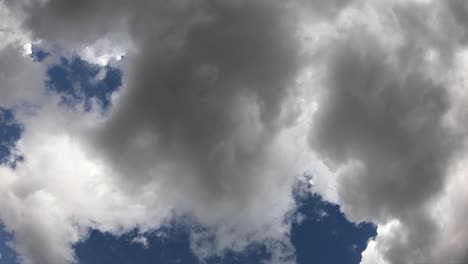 4k. timelapse of clouds in a blue sky. the sun's rays pass through clouds