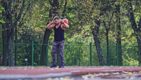 sportsman during workout at stadium. man doing exercises during workout at stadium