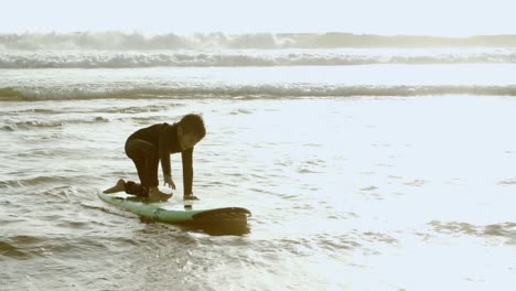 Boy-trying-to-surf-on-board