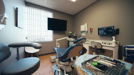 wide angle push in of a dentist's office or dental teeth cleaning room