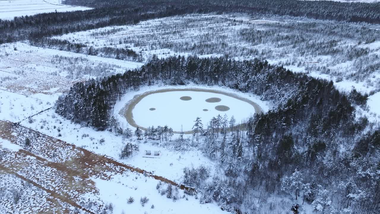 Drone shot of Medema bog in winter showing frozen lake circles like orbits