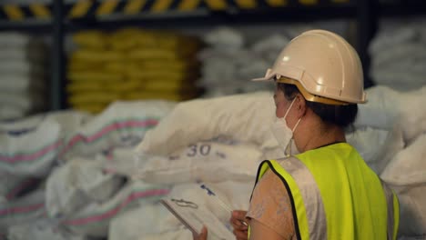 warehouse female worker is counting products and  check stock chemical industry.