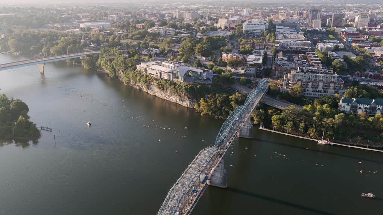 Drone shot captures swimmers moving downstream past Chattanooga’s iconic bridges and bluffs during the Ironman race