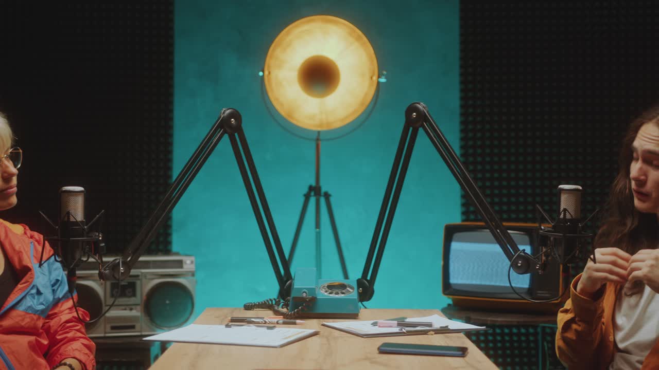 Young Podcaster Interviewing Female Guest in Audio Recording Studio