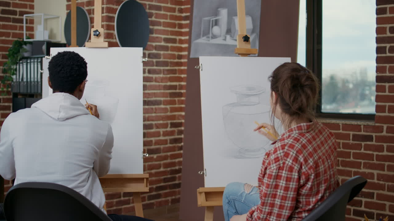 Diverse team on students drawing vase model on canvas