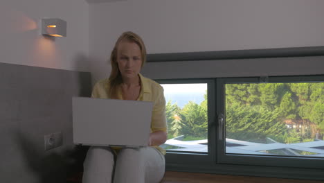 blonde woman working on laptop