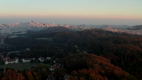 Aerial-slider-shot-over-San-Francisco-Presidio-with-the-city-skyline-in-the-background