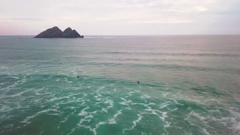 Surfers-waiting-to-catch-a-wave-in-a-calm-period-of-sea-movement