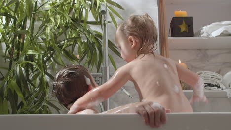 children bathing in foamy water