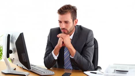 Anxious-businessman-sitting-at-his-desk