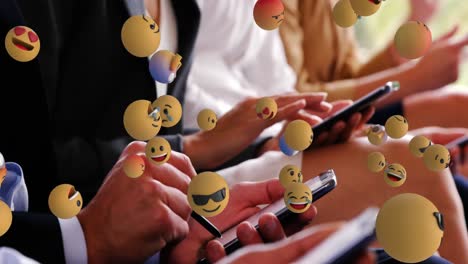 emoji icons with people using smartphones in the background 4k