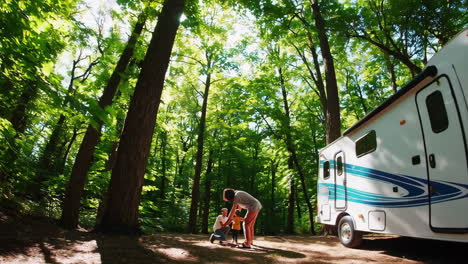 family enjoying an rv camping trip in a sunny forest