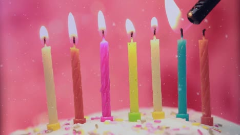 Animation-of-white-confetti-falling-over-colourful-birthday-cake-candles-being-lit-on-cake