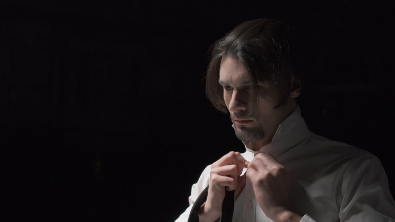 Man Adjusting Tie in Formal Wear