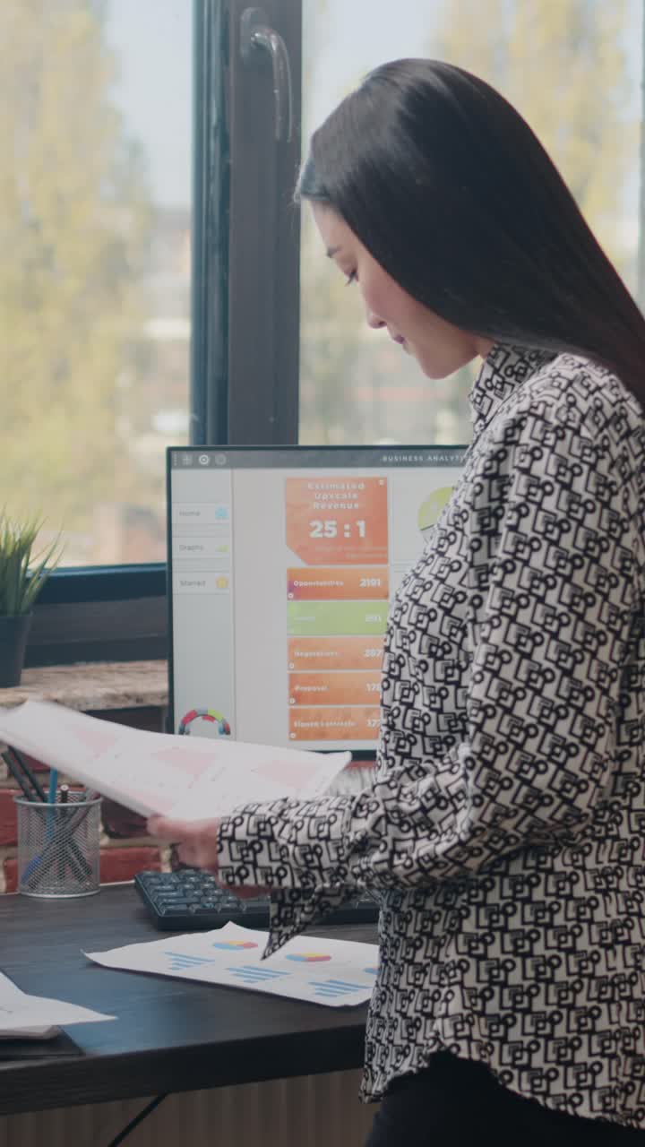 Businesswoman analyzing data in office
