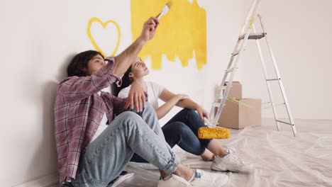 couple painting a wall in their new home