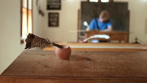 Profesora-O-Estudiante-En-Enfoque-Suave-Escribiendo-Notas-En-El-Aula-Con-Pluma-De-Tinta-De-Pluma