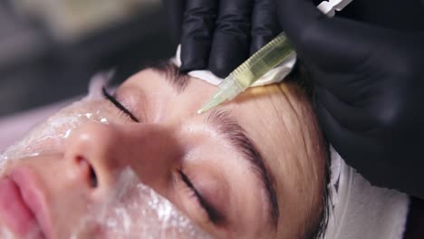 doctor makes multiple injections in woman's face skin during mesotherapy. biorevitalization and face lifting, non-surgical