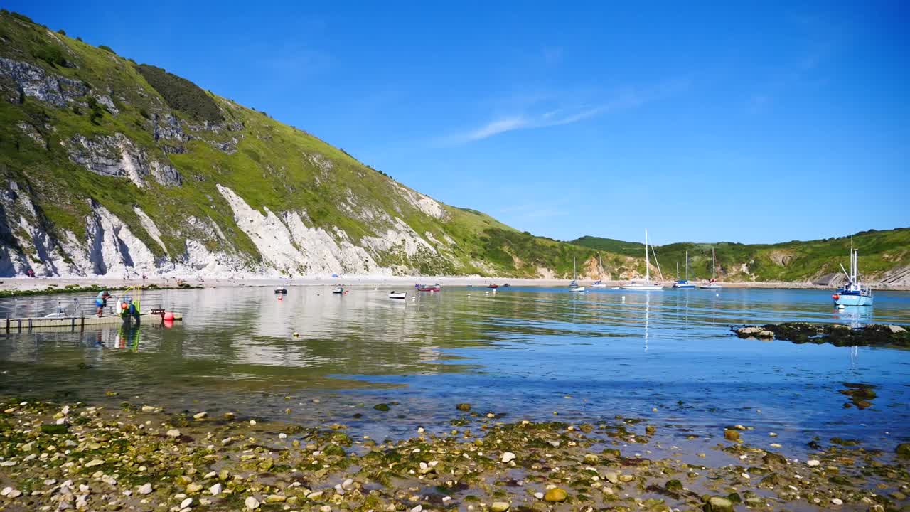 A cove with fishing boats leading out into the ocean