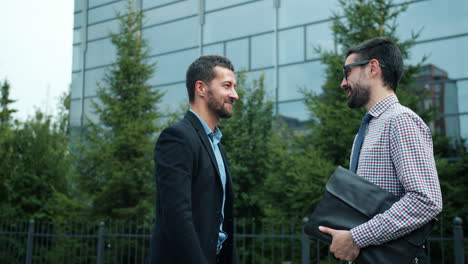 businessmen talking outdoors