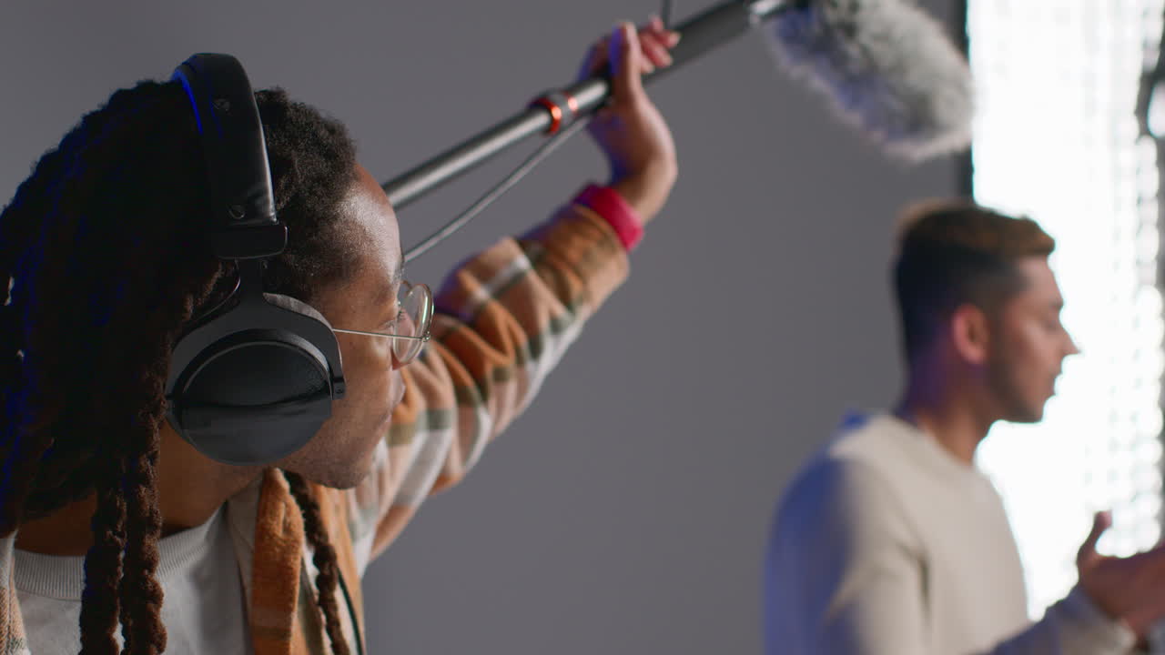 Audio Engineer Recording a Man with a Boom Microphone