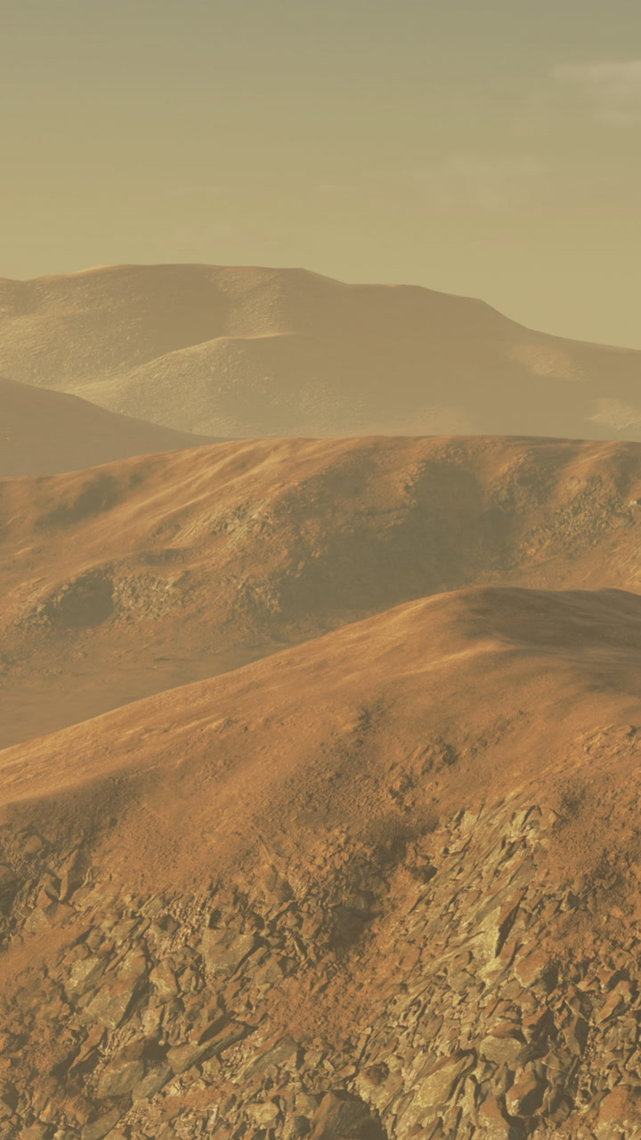 Hills and valleys in a dry landscape under a clear sky at sunset