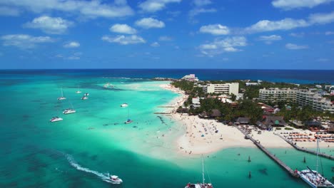 Aerial-Drone-Flyover-Clear-Blue-Water-And-Resort-In-Mexico-Playa-Norte,-Isla-Mujeres,-4K