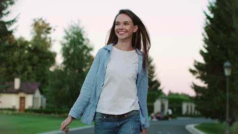 smiling woman walking on city street and meeting boyfriend with flowers