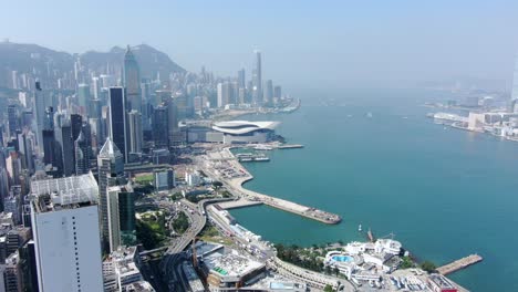 Hong-Kong-upscale-Wan-Chai-district-and-Victoria-Harbour-skyscrapers,-Aerial-view