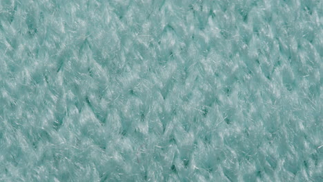 close-up of teal knitted fabric texture