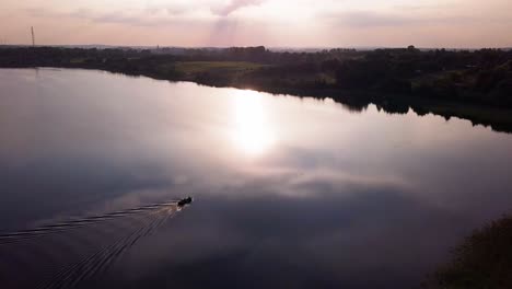 aerial shot of a secluded lake, surrounded by fields and farms