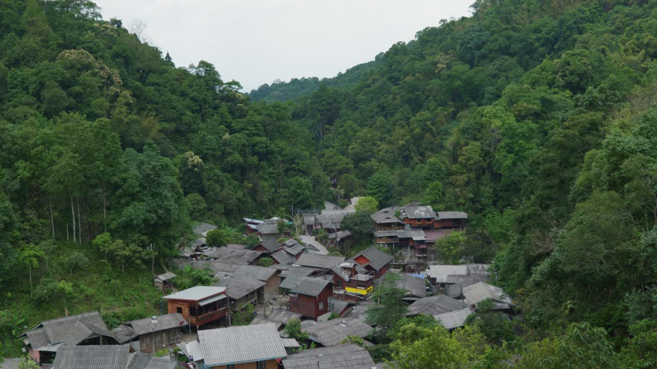4K Cinematic landscape nature footage of the famous and authentic village of Mae Kampong in the middle of the forest and the mountains of Northern Thailand on a sunny day