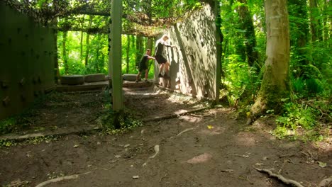 fit men training over obstacle course 4k