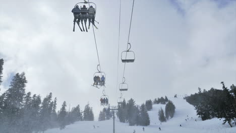 timelapse of people riding up a ski lift in the mountains