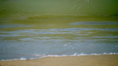 Foamy-waves-pounding-at-the-sandy-seaside-of-Pattaya-Beach,-situated-in-Chonburi-province-in-Thailand