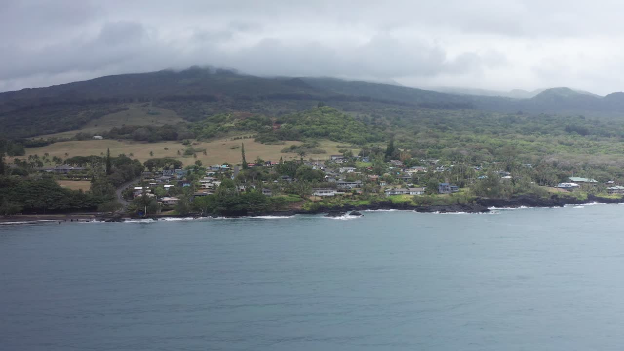 Aerial low panning shot flying over Hana Bay towards the small town of Hana on the windward coast of Maui, Hawai'i