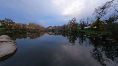 Low-angle-aerial-fpv-drone-shot-over-Tâmega-river-at-Amarante,-Portugal