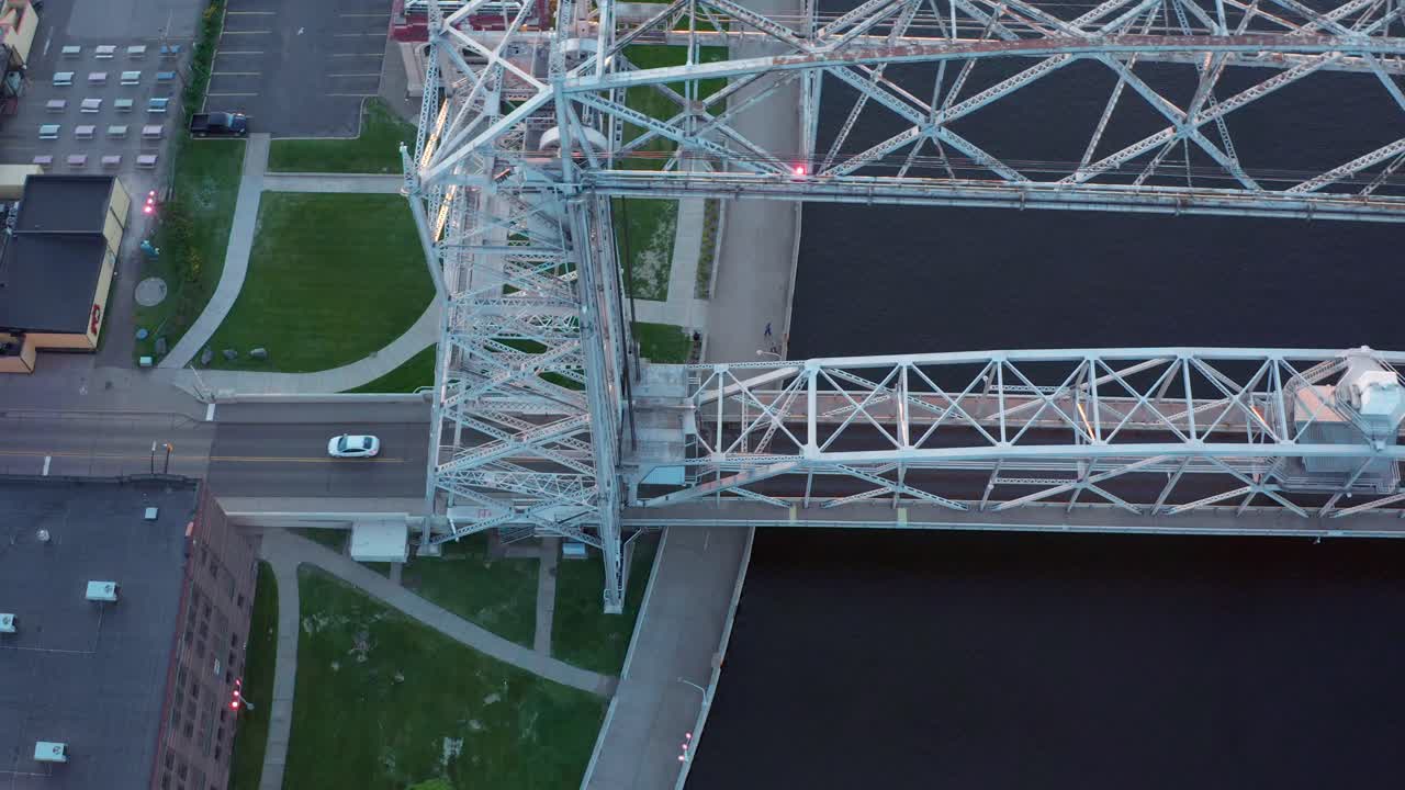 vista aérea de arriba hacia abajo a lo largo del puente elevador que atraviesa el canal del lago superior en duluth, minnesota - seguimiento de arriba hacia abajo de drones