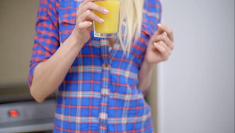 sexy bottomless woman drinking orange juice