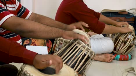closeup of beginner tabla players learning to play music.