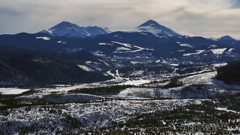 downtown frisco toward breckenridge colorado aerial cinematic drone lake dillon marina keystone summit cove cloudy snowy winter morning view silverthorne ten mile range forward reveal