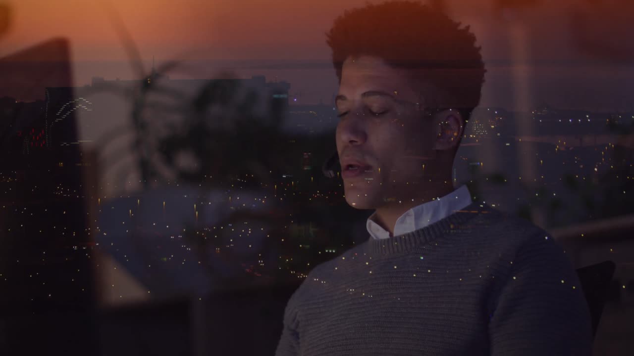 Animation of biracial businessman using phone over data processing and cityscape