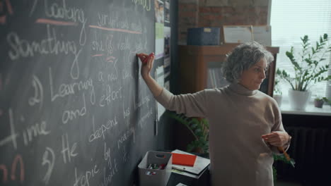 female teacher giving english grammar lesson in classroom