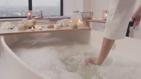 camera focuses on a bathtub full of water and foam