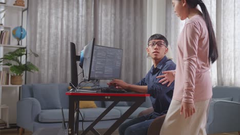 two young people collaboratively programming